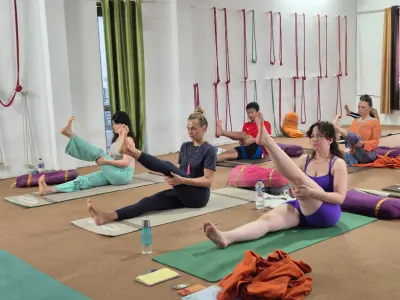 Students practicing seated yoga poses during a 100 Hour Yoga Teacher Training course