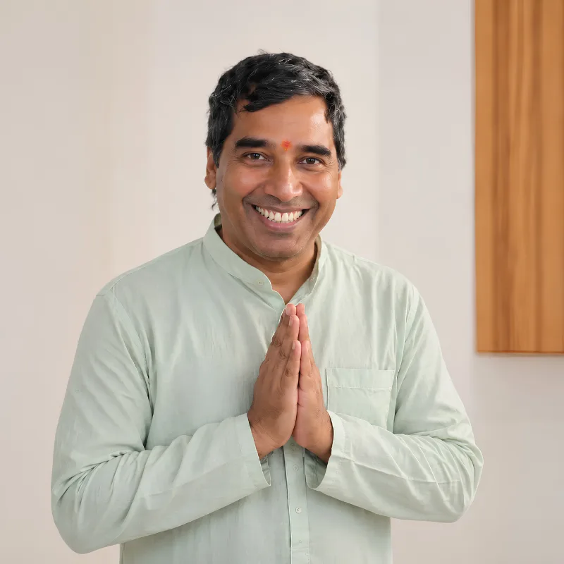 Upendra Silswal, yoga training course teacher in Rishikesh, India, greeting students with a traditional Namaste gesture