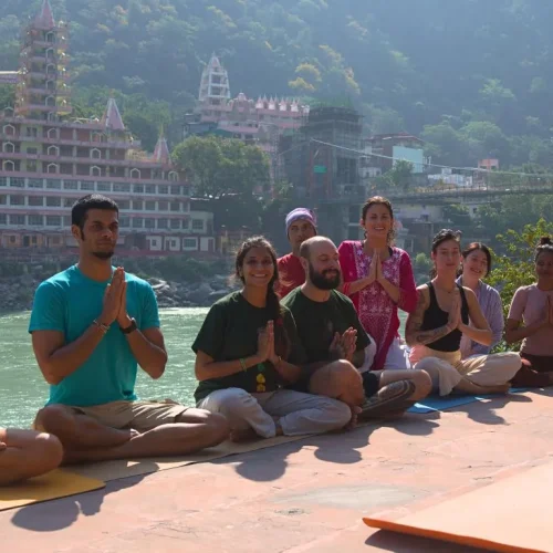 yoga teacher training students near ganga river